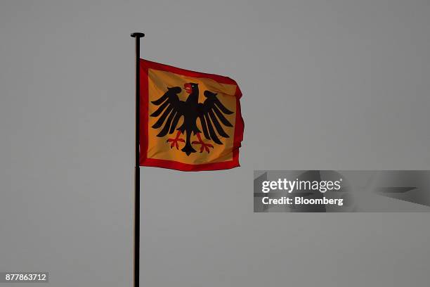 An eagle adorns the Presidential flag as it flies over the Schloss Bellevue Presidential Palace as Germany's President Frank-Walter Steinmeier holds...