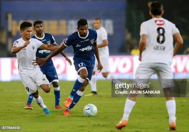 Chennaiyin FC Dhanapal Ganesh vies for the ball with NorthEast United FC Seiminlen Doungel during the Indian Super League football league match...