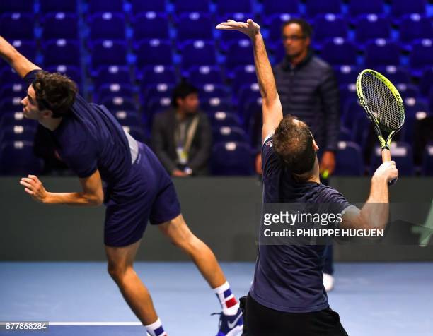 French tennis players Pierre-Hugues Herbert and Richard Gasquet practice during a training session on November 23, 2017 at the Pierre-Mauroy stadium...