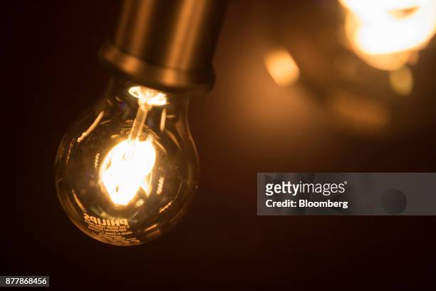 Filaments glow inside Philips Classic LED light bulbs at the Philips Lighting NV experience center in Eindhoven, Netherlands, on Thursday, Nov. 23,...