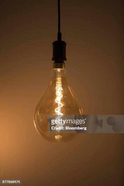 Filament glows inside a Philips Classic LED light bulb at the Philips Lighting NV experience center in Eindhoven, Netherlands, on Thursday, Nov. 23,...