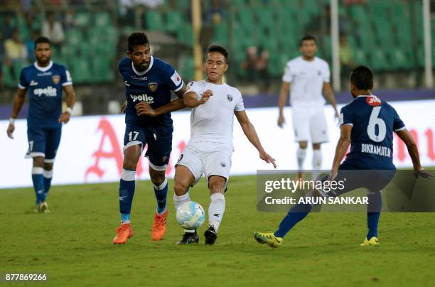 Chennaiyin FC Dhanapal Ganesh vies for the ball with NorthEast United FC Ralte during the Indian Super League football league match between...