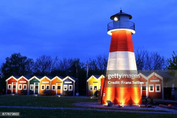 lighthouse and typical colorful fishermen's huts (hummerbuden) on helgoland island, germany - heligoland stock pictures, royalty-free photos & images