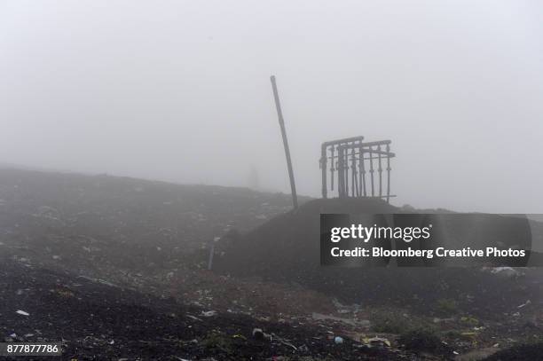 a landfill gas extraction wellhead sits atop a capped landfill - oceana stock pictures, royalty-free photos & images