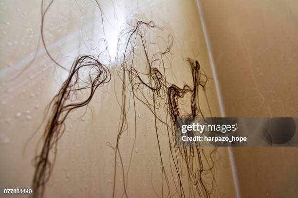 long strands of hair stuck to a shower wall. - harpazo hope stock pictures, royalty-free photos & images