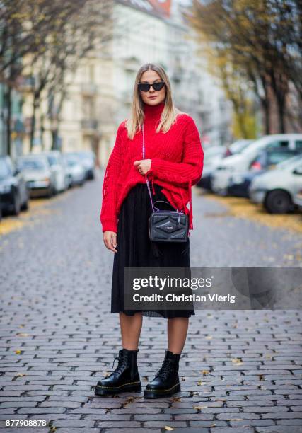 Alessa Winter wearing red knit Bershka, black Laurel bag, black midi skirt Naked, black Dr. Martens boots on November 23, 2017 in Berlin, Germany.