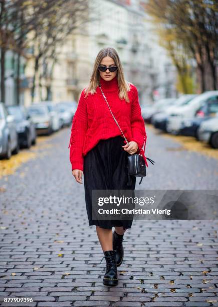 Alessa Winter wearing red knit Bershka, black Laurel bag, black midi skirt Naked, black Dr. Martens boots on November 23, 2017 in Berlin, Germany.