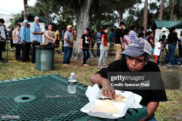 Man eats at the annual Thanksgiving in the Park gathering where residents of the farm worker community of Immokalee are provided with a free...