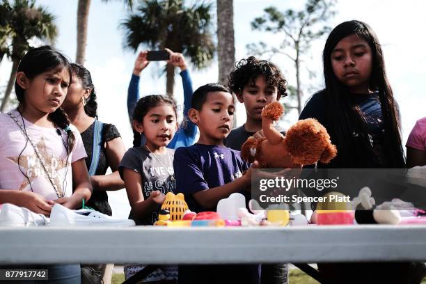 Children look through donated toys at the annual Thanksgiving in the Park gathering where residents of the farm worker community of Immokalee are...