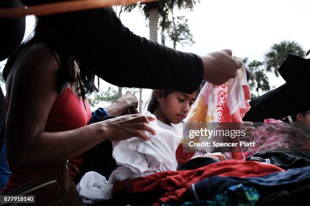 People look through donated clothes at the annual Thanksgiving in the Park gathering where residents of the farm worker community of Immokalee are...