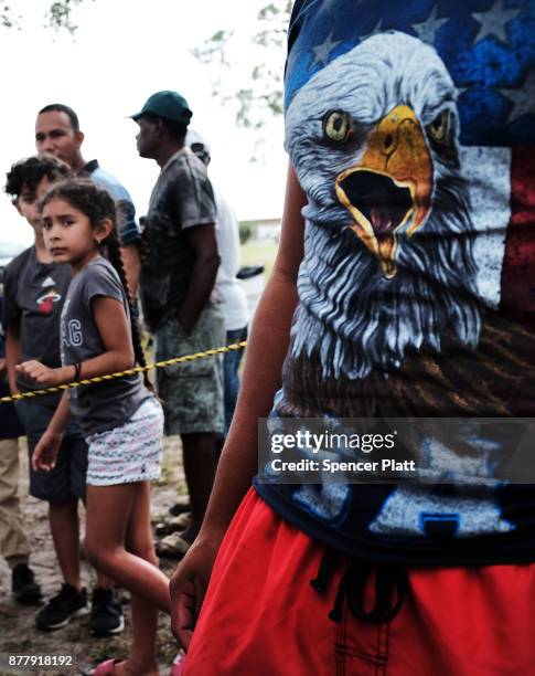 Families wait for food to be served at the annual Thanksgiving in the Park gathering where residents of the farm worker community of Immokalee are...