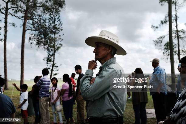 Families wait for food to be served at the annual Thanksgiving in the Park gathering where residents of the farm worker community of Immokalee are...