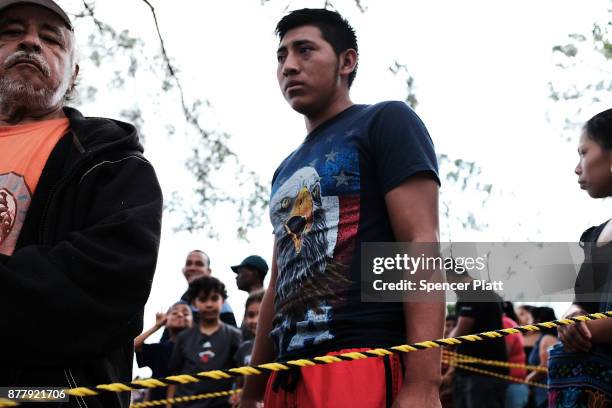 Families wait for food to be served at the annual Thanksgiving in the Park gathering where residents of the farm worker community of Immokalee are...