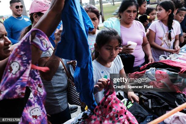 People look through donated clothes at the annual Thanksgiving in the Park gathering where residents of the farm worker community of Immokalee are...