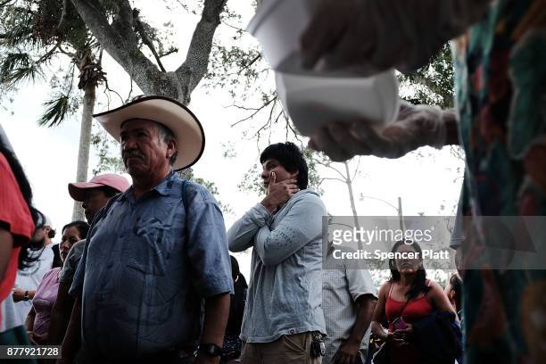 Families wait for food to be served at the annual Thanksgiving in the Park gathering where residents of the farm worker community of Immokalee are...