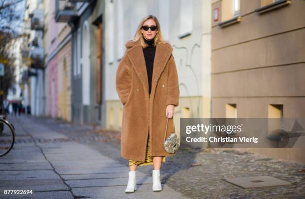 Sonia Lyson wearing a brown teddy coat Max Mara, Gigi Hadid x Vogue Eyewear sunglasses, white lack boots Edited, yellow skirt with animal print...