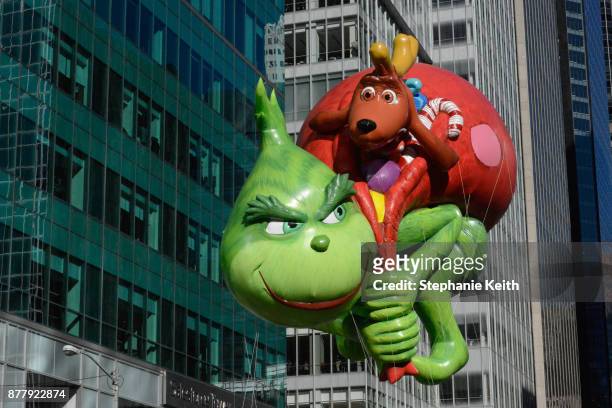 The Grinch balloon floats on 6th Ave. During the annual Macy's Thanksgiving Day parade on November 23, 2017 in New York City. The Macy's Thanksgiving...