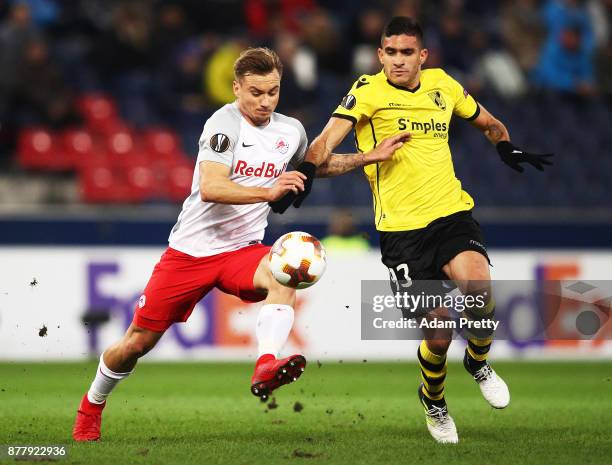Fredrik Gulbrandsen of Red Bull Salzburg is challenged by Guillermo Celis of Vitoria Guimaraes during the UEFA Europa League group I match between FC...