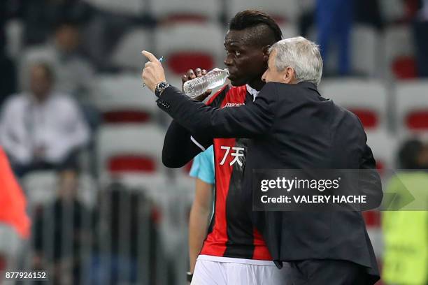 Nice's Italian forward Mario Balotelli listens to Nice's Swiss head coach Lucien Favre after scoring a goal during the UEFA Europa League football...