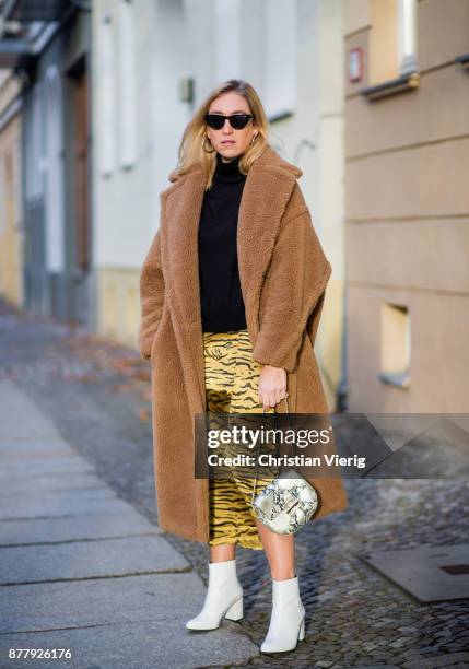 Sonia Lyson wearing a brown teddy coat Max Mara, Gigi Hadid x Vogue Eyewear sunglasses, white lack boots Edited, yellow skirt with animal print...