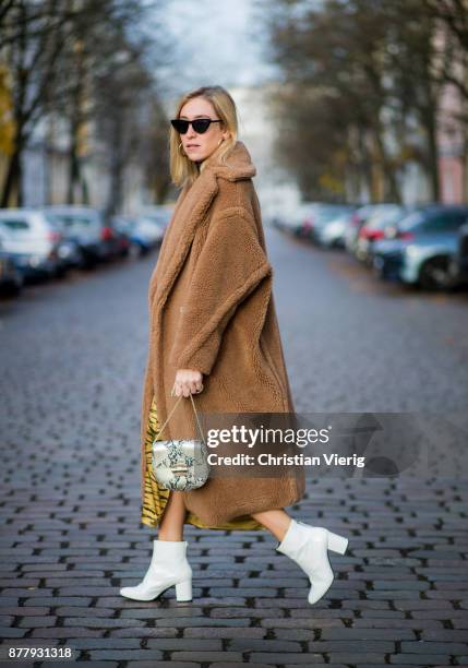 Sonia Lyson wearing a brown teddy coat Max Mara, Gigi Hadid x Vogue Eyewear sunglasses, white lack boots Edited, yellow skirt with animal print...