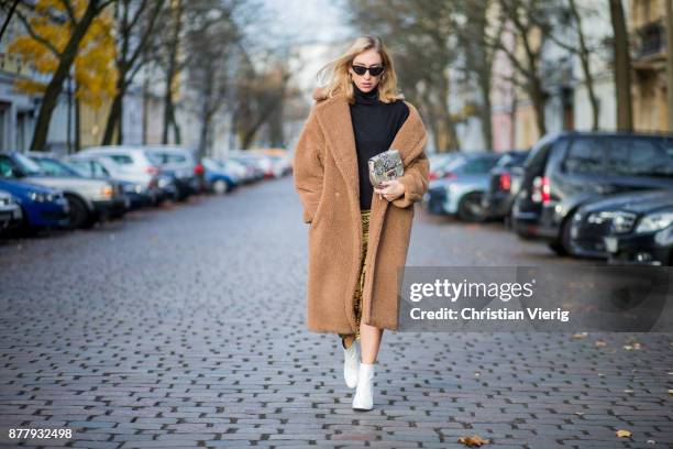 Sonia Lyson wearing a brown teddy coat Max Mara, Gigi Hadid x Vogue Eyewear sunglasses, white lack boots Edited, yellow skirt with animal print...