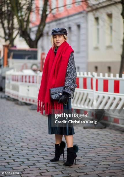 Sonia Lyson wearing red scarf, black leather vintage hat, black ankle boots with fur Jimmy Choo, black Chanel bag, pleated midi skirt zara, grey knit...