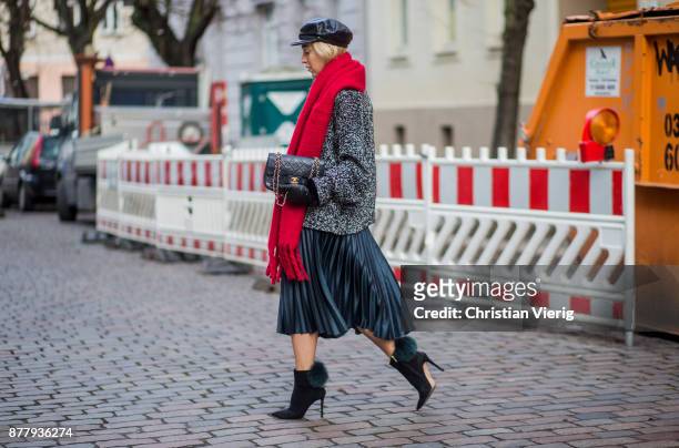 Sonia Lyson wearing red scarf, black leather vintage hat, black ankle boots with fur Jimmy Choo, black Chanel bag, pleated midi skirt zara, grey knit...