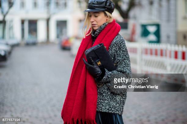 Sonia Lyson wearing black leather vintage hat, red Zara scarf, black ankle boots with fur Jimmy Choo, black Chanel bag, pleated midi skirt zara, grey...