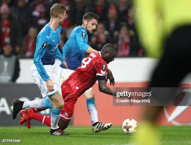 Sehrou Guirassy of FC Koeln falls in the penalty box during the UEFA Europa League group H match between 1. FC Koeln and Arsenal FC at...