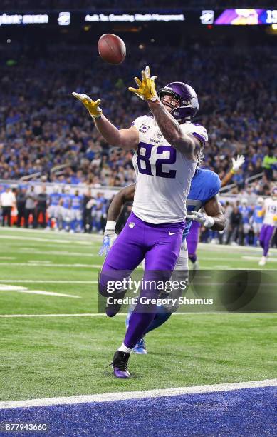 Kyle Rudolph of the Minnesota Vikings catches a pass over his shoulder against the Detroit Lions for a touchdown during the second quarter at Ford...