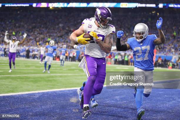 Kyle Rudolph of the Minnesota Vikings catches a pass against Glover Quin of the Detroit Lions for a touchdown during the second quarter at Ford Field...