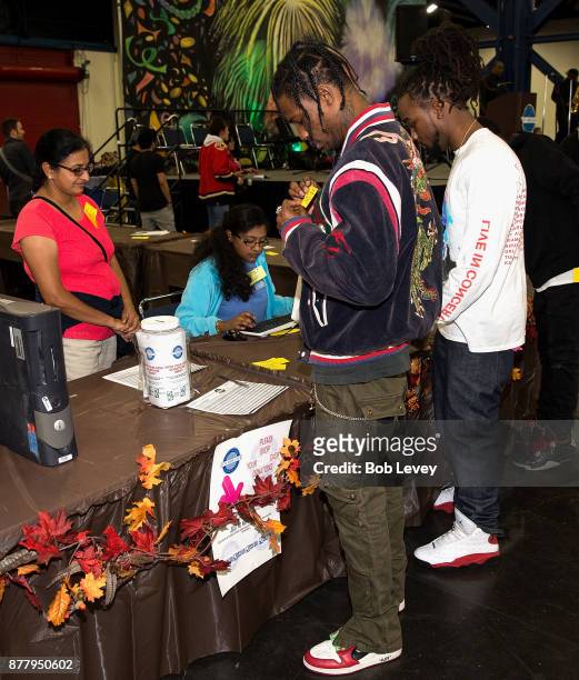 Travis Scott helps distribute clothing during the Houston City Wide Club of Clubs Turkey Drive on November 23, 2017 in Houston, Texas.
