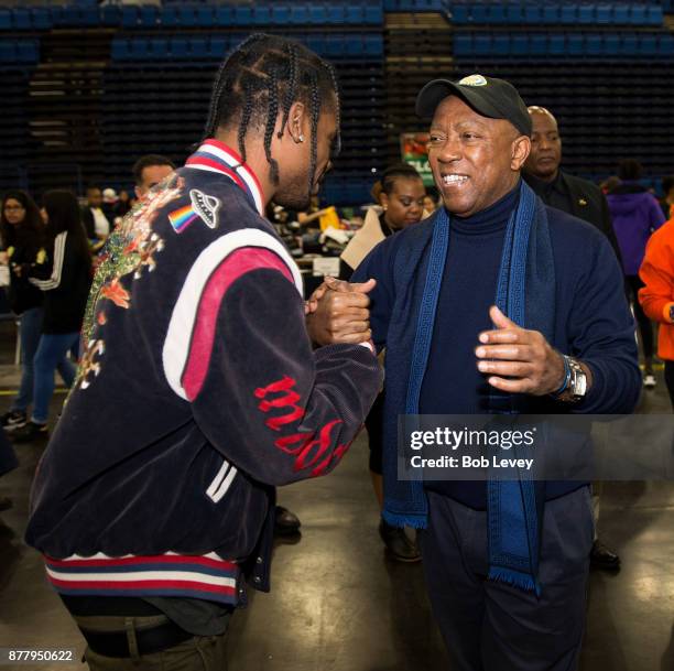 Travis Scott meetsHouston Mayor Sylvester Turner during the Houston City Wide Club of Clubs Turkey Drive on November 23, 2017 in Houston, Texas.