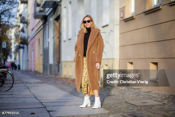 Sonia Lyson wearing a brown teddy coat Max Mara, Gigi Hadid x Vogue Eyewear sunglasses, white lack boots Edited, yellow skirt with animal print...