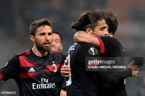 Milan's Swiss defender Ricardo Rodriguez celebrates with teammates after scoring the UEFA Europa League group D football match between AC Milan and...