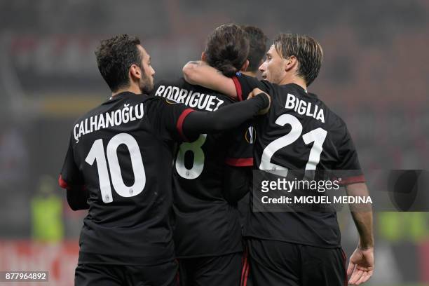 Milan's Swiss defender Ricardo Rodriguez celebrates with teammates after scoring the UEFA Europa League group D football match between AC Milan and...
