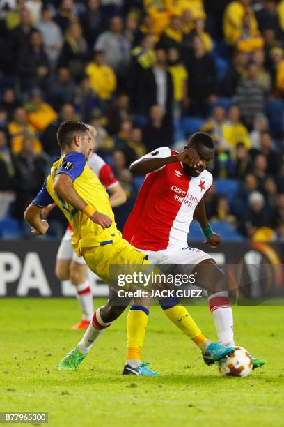 Slavia's Cameroonian defender Michael Ngadeu-Ngadjui is marked by Maccabi's Israeli defender Eitan Tibi during the Europa League Group A football...