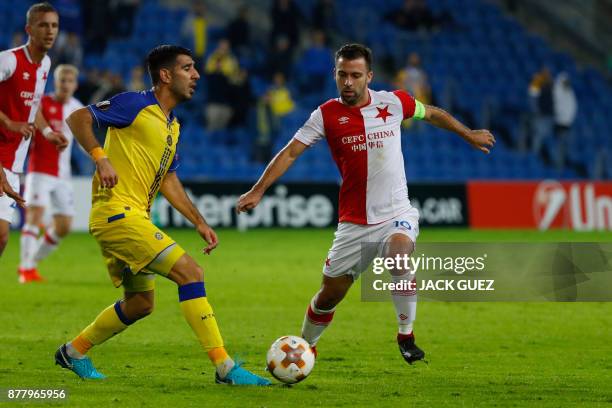 Maccabi's Israeli defender Eitan Tibi is marked by Slavia's Czech midfielder Josef Husbauer during the Europa League Group A football match between...