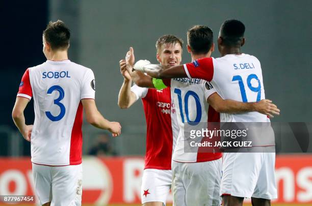 Slavia's Czech midfielder Josef Husbauer celebrates his goal with teammates during the Europa League Group A football match between Maccabi Tel Aviv...