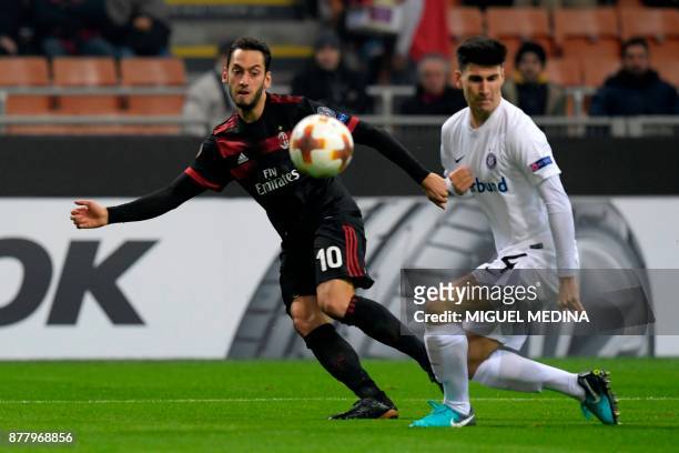 Milan's German midfielder Hakan Calhanoglu kicks the ball during the UEFA Europa League group D football match between AC Milan and FK...