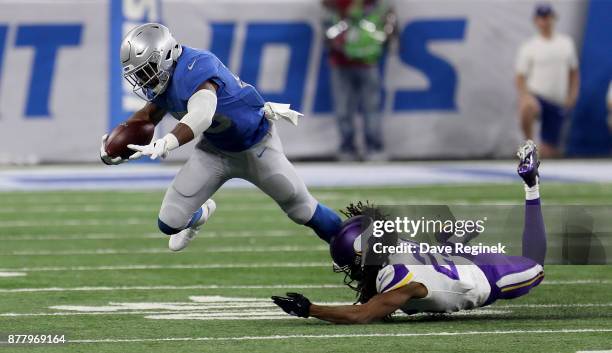 Theo Riddick of the Detroit Lions runs the ball against Trae Waynes of the Minnesota Vikings during the second half at Ford Field on November 23,...