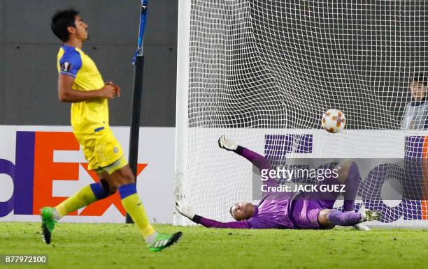 Maccabi's Serbian goalkeeper Predrag Rajkovic attempts to save a goal during the Europa League Group A football match between Maccabi Tel Aviv and...
