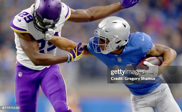 Marvin Jones of the Detroit Lions fights off defender Xavier Rhodes of the Minnesota Vikings after catching a pass during the first half at Ford...