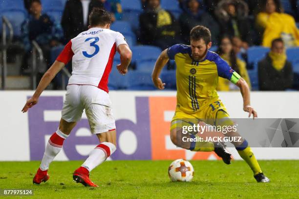 Slavia's Ukranian defender Eduard Sobol marks Maccabi's Israeli midfielder and captain Sheran Yeini during the Europa League Group A football match...