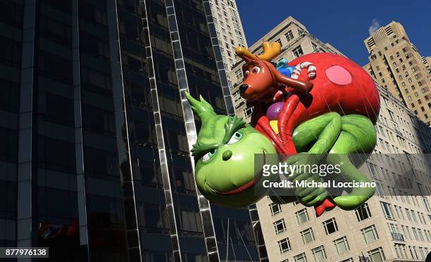 The Dr. Seuss Grinch and Max balloon floats down Central Park West and into Columbus Circle during the 91st Annual Macy's Thanksgiving Day Parade on...