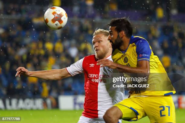 Slavia's Dutch forward Mick van Buren vies for the ball with Maccabi's Israeli defender Ofir Davidzada during the Europa League Group A football...