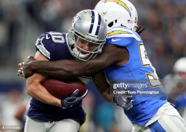 Ryan Switzer of the Dallas Cowboys is stopped by Melvin Ingram of the Los Angeles Chargers in the first quarter of a football game at AT&T Stadium on...