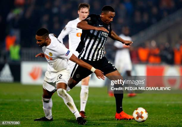 Partizan's Leandre Tawamba fights for the ball with Gregory Wuthrich of Young Boys during the UEFA Europa League football match between Partizan...
