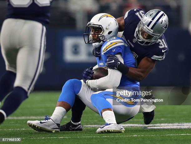 Keenan Allen of the Los Angeles Chargers is tackled by Byron Jones of the Dallas Cowboys in the first quarter of a football game at AT&T Stadium on...